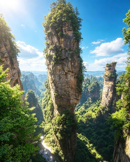 A towering rock formation surrounded by lush greenery and a river. 5