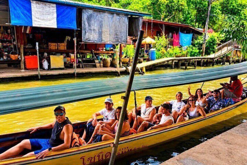 A yellow boat with passengers on a river. 2