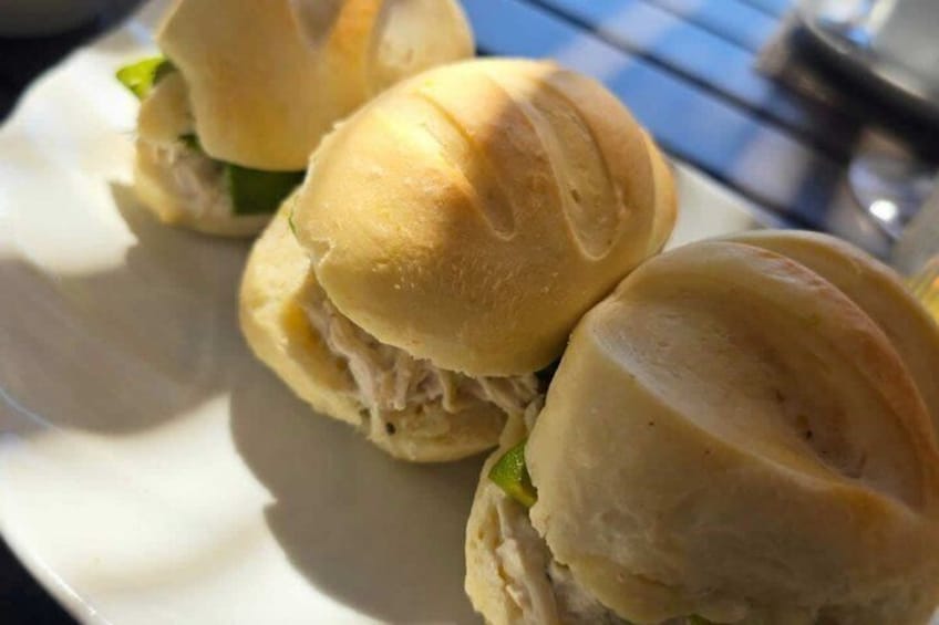 Three sandwiches on a white plate. 3