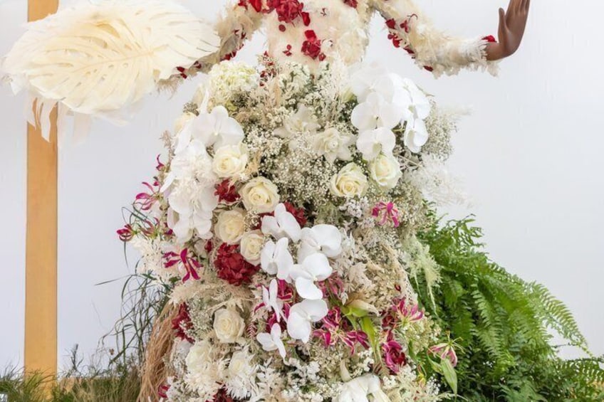 A floral arrangement with white, red, and pink flowers, and green foliage. 2