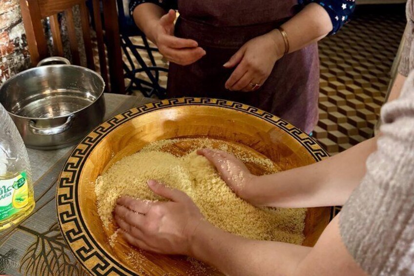 A person mixing ingredients in a wooden bowl. 5