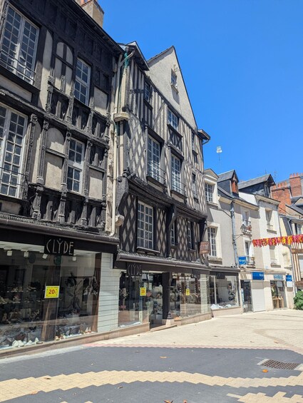 A traditional half-timbered building with a shoe store named 'Clyde' on the ground floor. 5