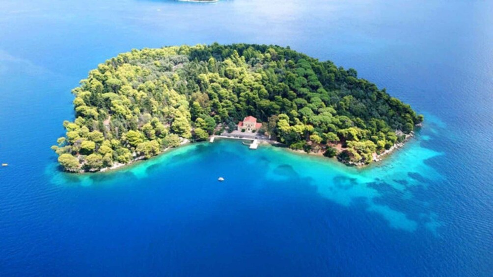 An island surrounded by clear blue waters. 3