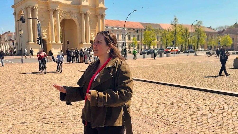 A person standing on a cobblestone street with a historic building in the background. 5