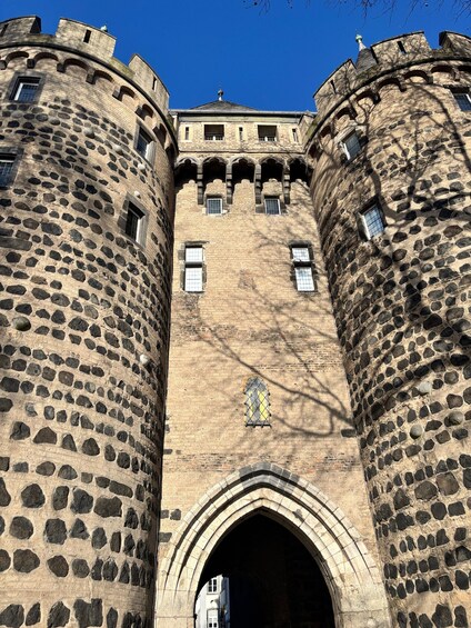 A historic stone castle with arched windows and a central entrance. 3