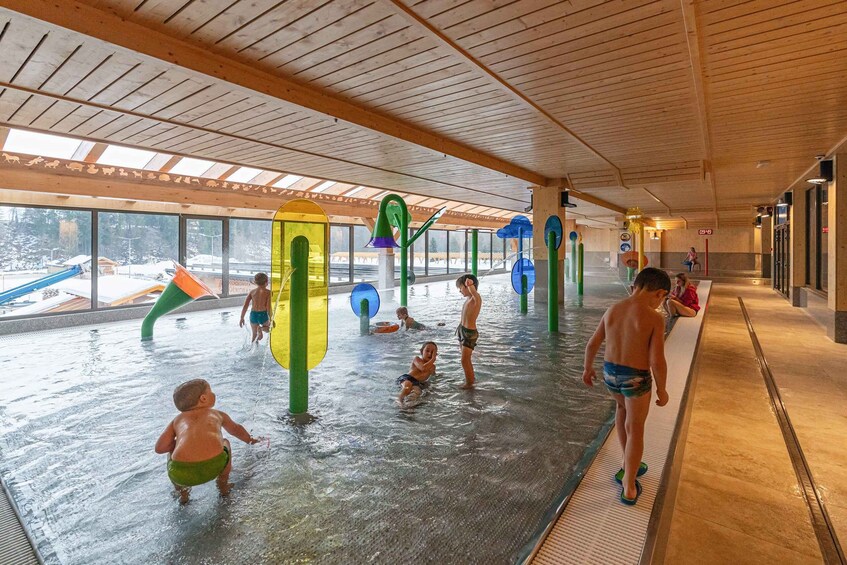 An indoor water play area with slides and water features. 3