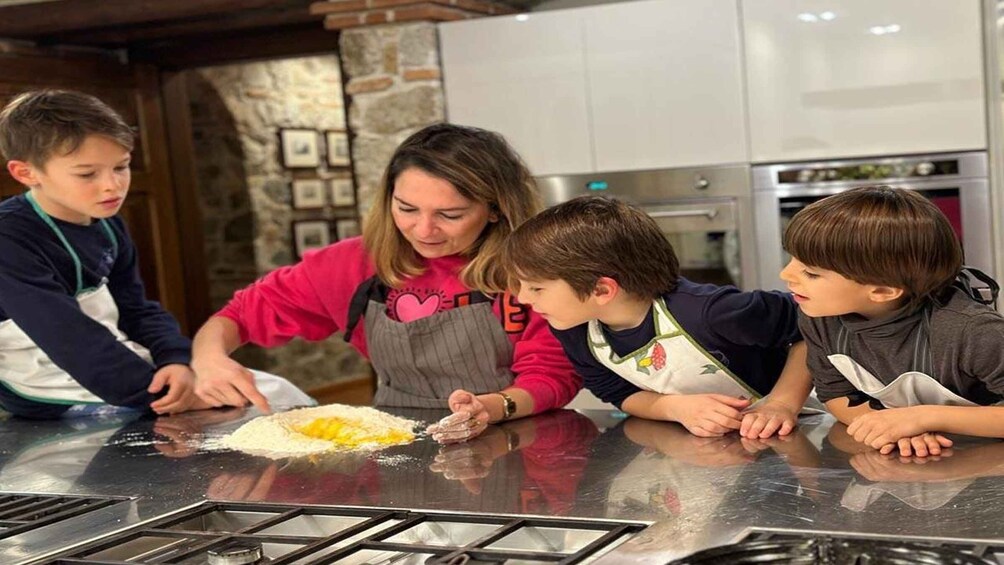 A family cooking together in a modern kitchen with a gas stove and a stone wall. 2