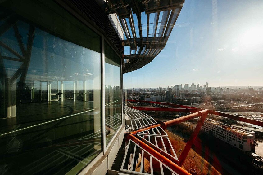 A high-rise building with a glass facade overlooking a cityscape. 5