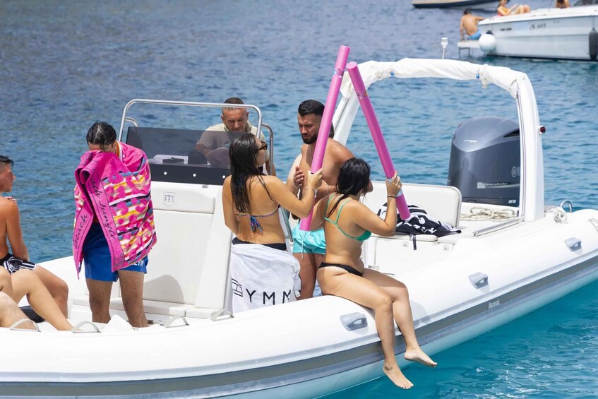 A group of people on a boat with a Yamaha outboard motor, surrounded by water. 5