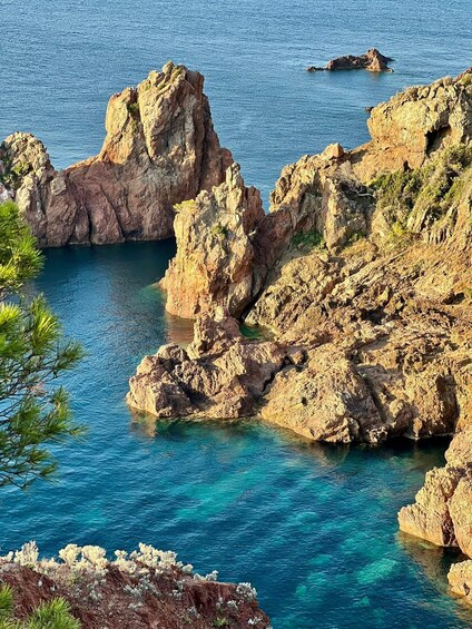 A rocky coastline with clear blue waters and sparse vegetation. 2
