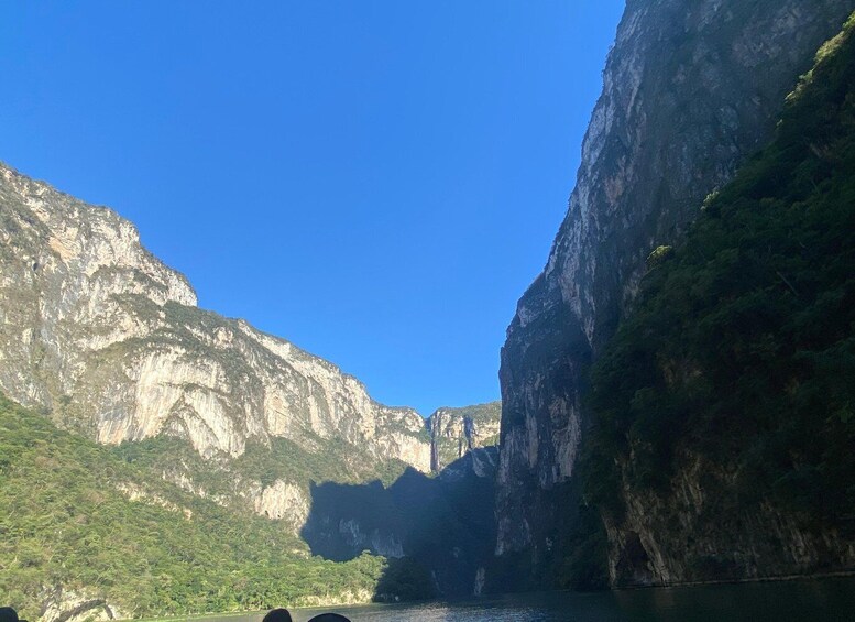 A canyon with steep cliffs and a river. 2