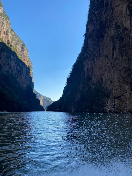 A river canyon with steep cliffs and clear blue sky. 4