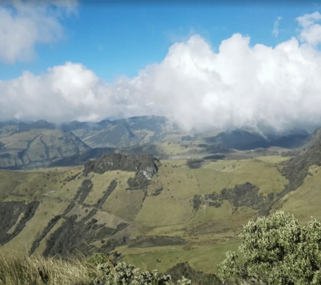 A mountainous landscape with rolling hills and a valley. 1