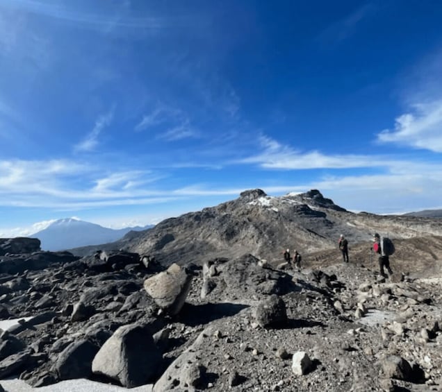 A rocky mountain landscape with hikers. 4