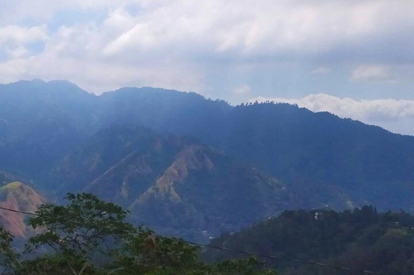 A mountain range with a cloudy sky. 3
