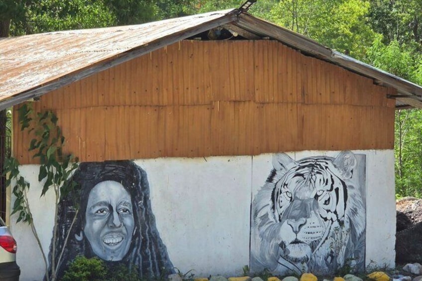 A building with a mural of a tiger and a person. 4