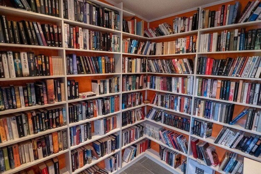 A large, well-organized library with numerous bookshelves filled with books. 4