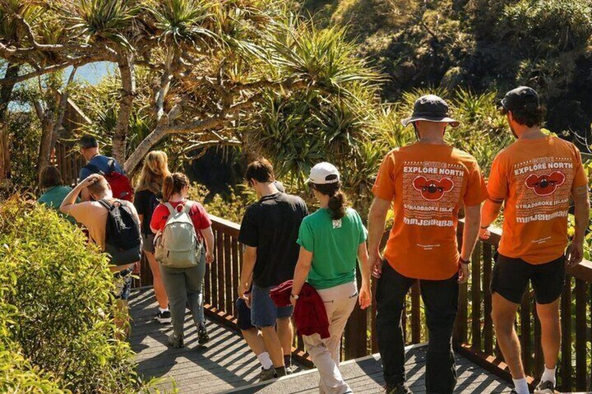 People walking on a pathway surrounded by greenery. 5