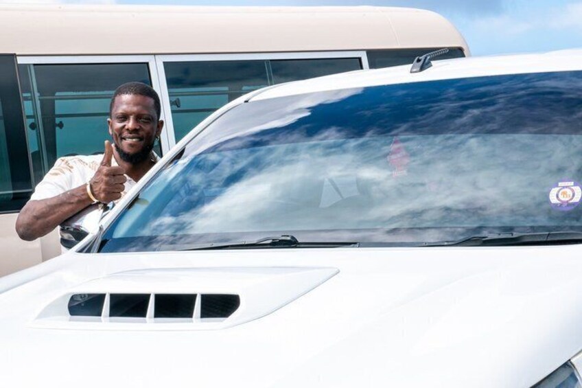 A white car with a person giving a thumbs-up gesture. 2