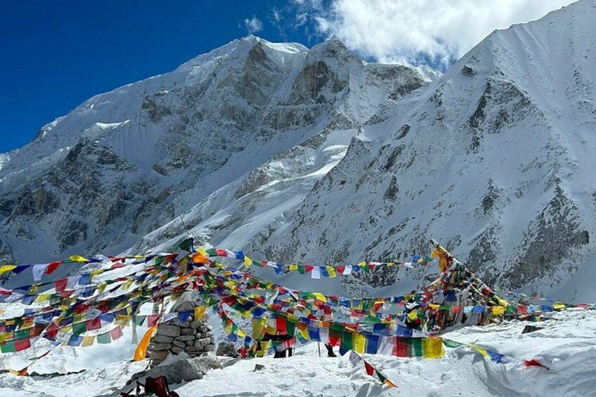A snow-covered mountain with colorful prayer flags. 1