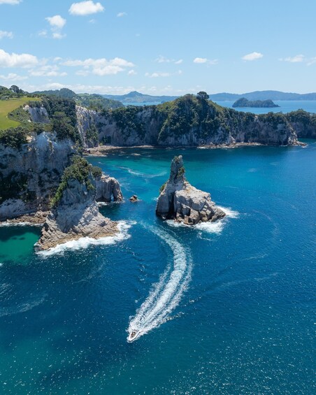 A coastal landscape with rocky outcrops and clear blue waters. 3