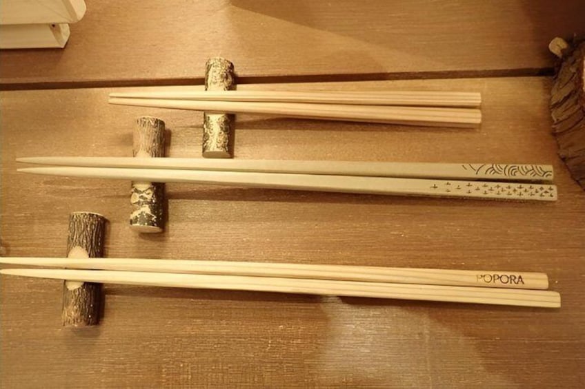 Chopsticks, chopstick holders, and a wooden surface. 1