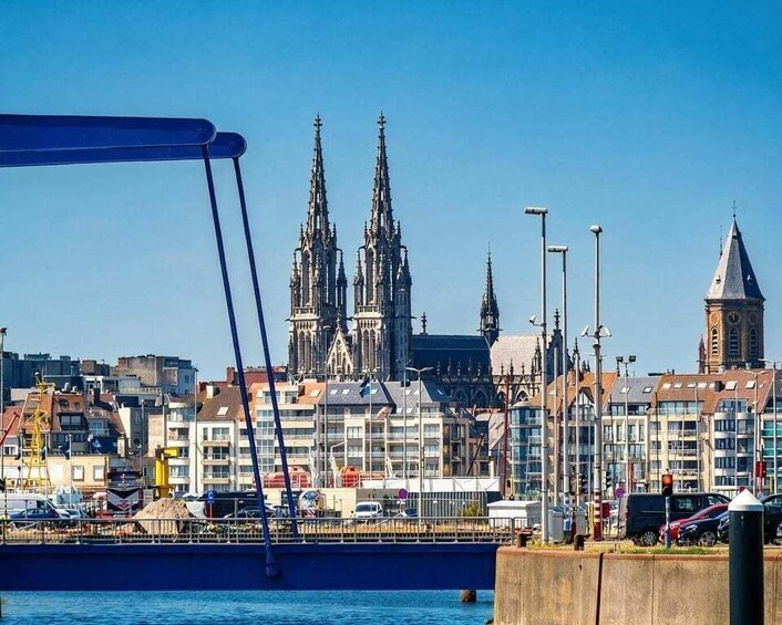A cityscape with a prominent cathedral, a bridge, and a waterfront. 1