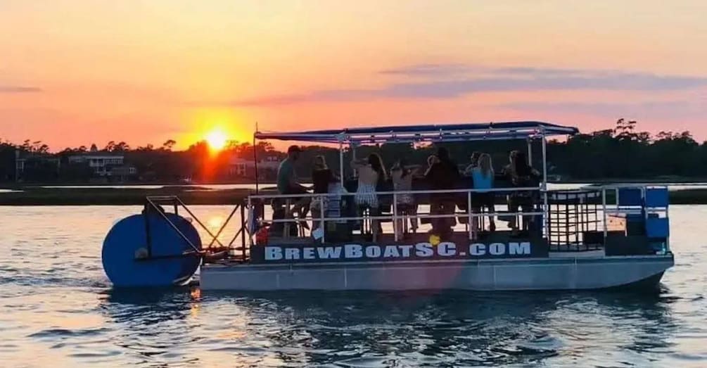 A boat with people on board during sunset. 2