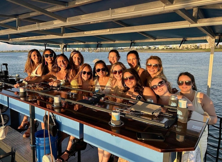 A group of people on a boat with a bar and drinks. 1