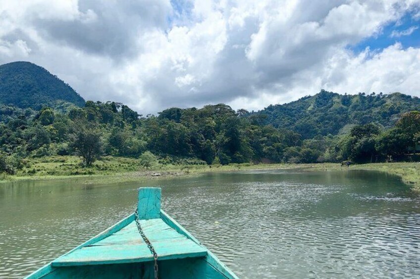 A boat on a calm lake with mountains in the background. 3