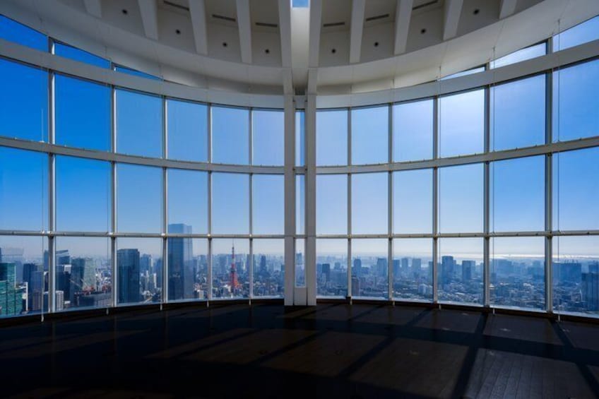 A high-rise interior with large windows offering a cityscape view. 3
