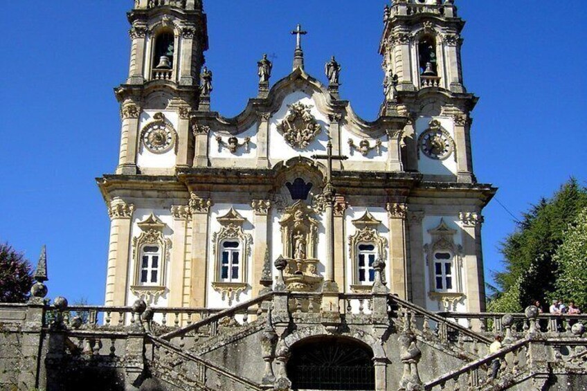 A historic church with two bell towers, ornate facade, and a central dome. 2
