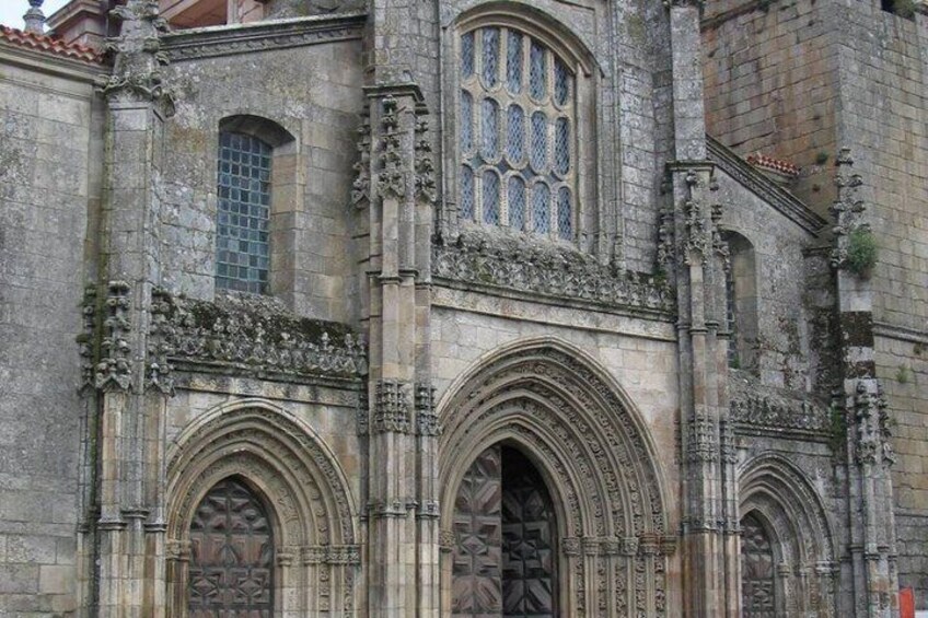 A historic stone building with ornate Gothic arches and detailed carvings. 5