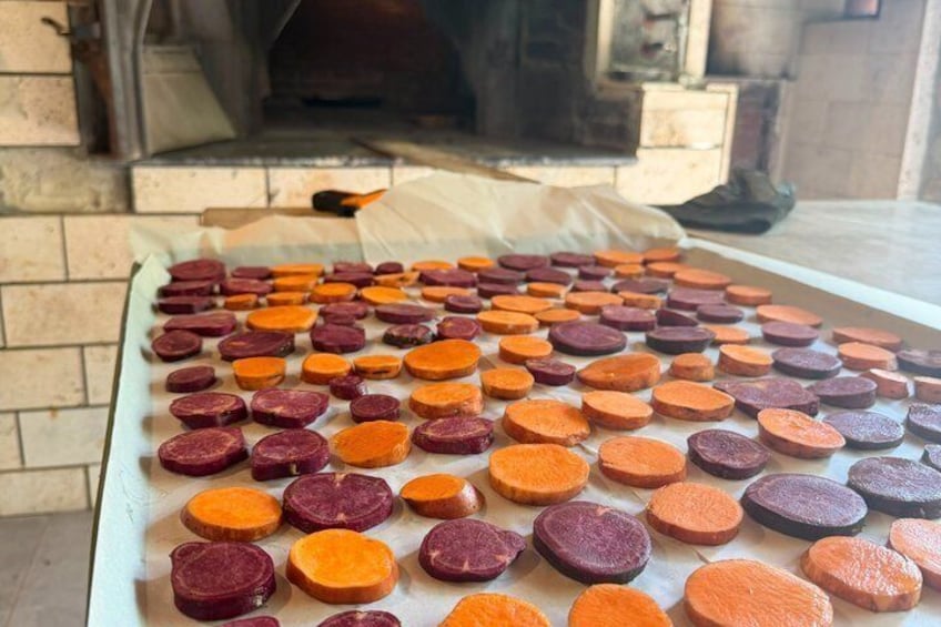 A tray of sliced beets arranged on a table. 3
