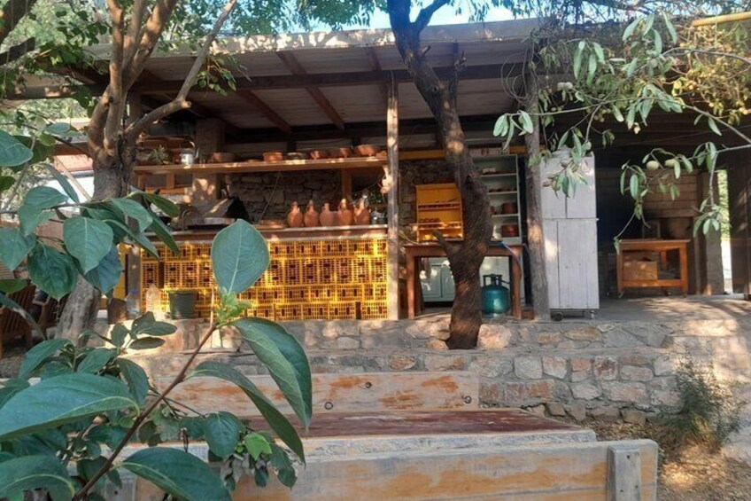 A rustic building with a stone facade, wooden beams, and a covered patio area. 5