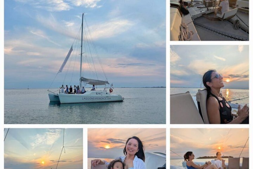 A sailboat on calm waters with a sunset in the background. 1