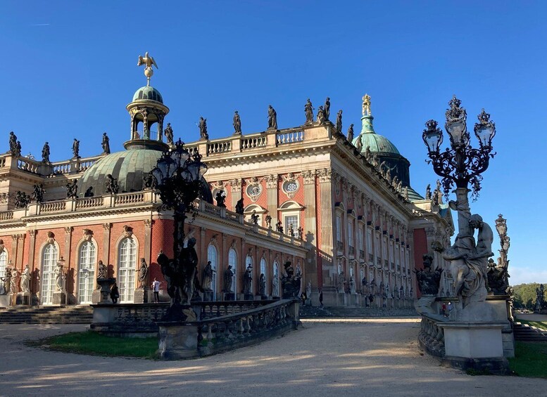 A grand historical building with ornate statues and a large dome. 4
