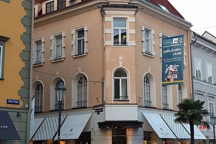 A building with arched windows and a banner advertising a jubilee year celebration. 4