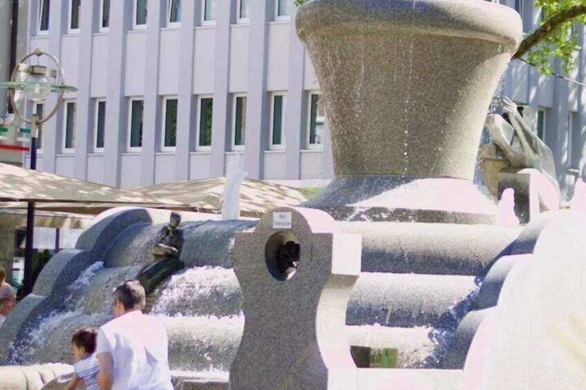 A water fountain with multiple streams and a large central spout. 4