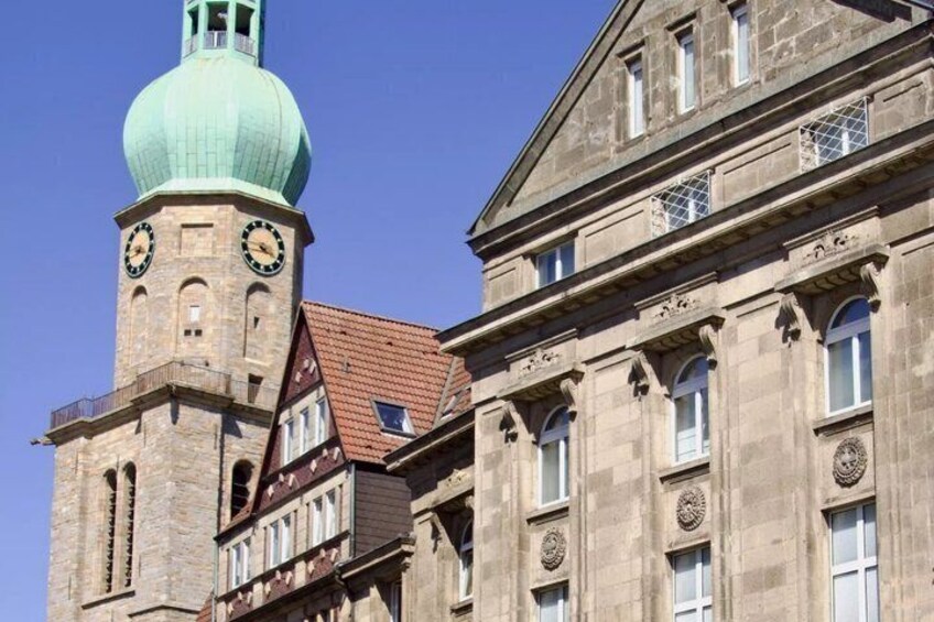 A historic building with a clock tower and a dome. 5