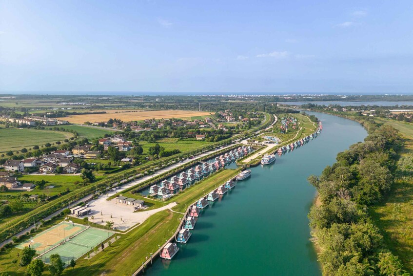 A river with houses and boats along the banks. 4