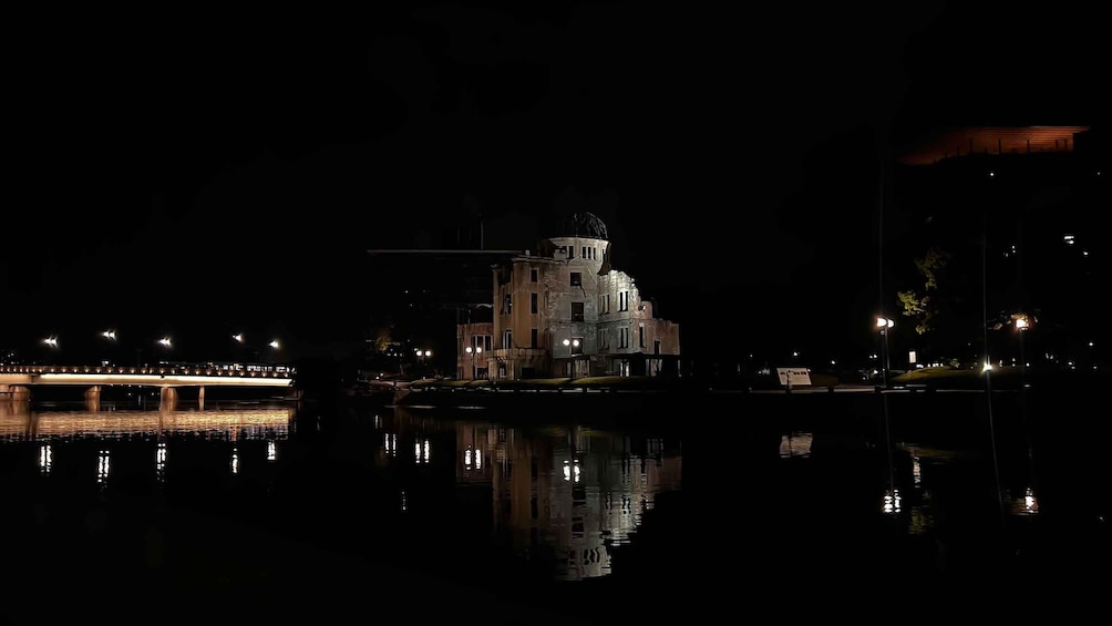 A historic building with a dome, reflecting on the water. 2