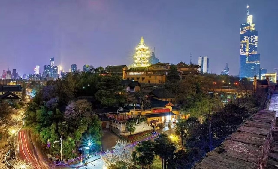 A traditional pagoda with illuminated lights, a modern skyscraper, and a cityscape at night. 1