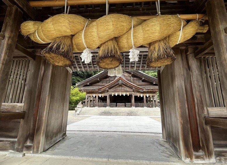 A traditional wooden structure with straw decorations hanging from the ceiling. 5