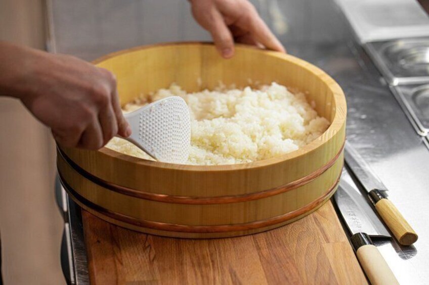 A person grating cheese into a wooden bowl. 5