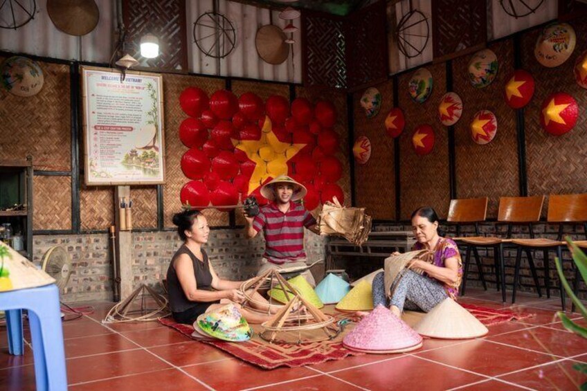 A traditional Vietnamese setting with a bamboo ceiling, red lanterns, and a star decoration. 1