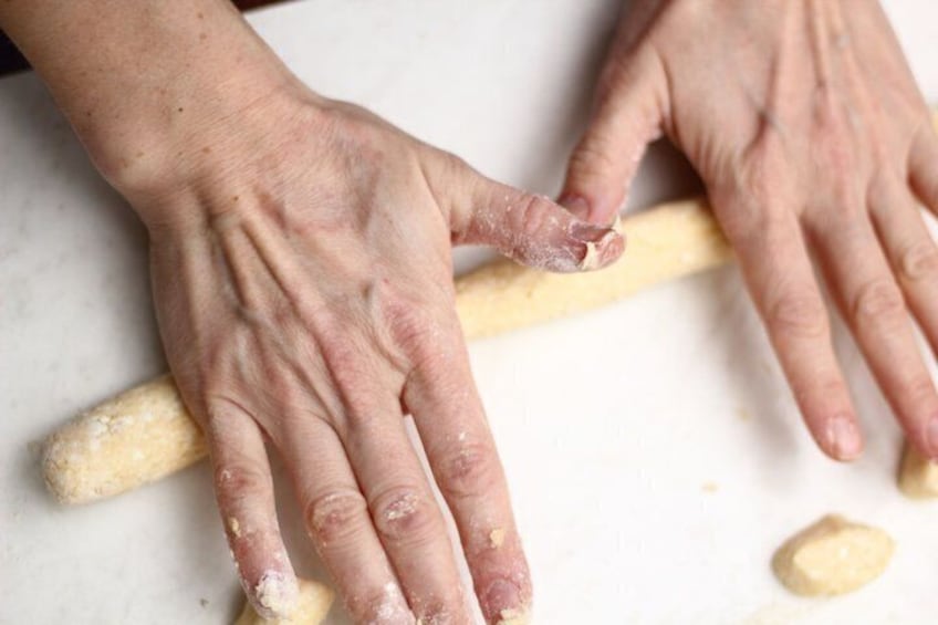 Hands kneading dough on a marble surface. 4
