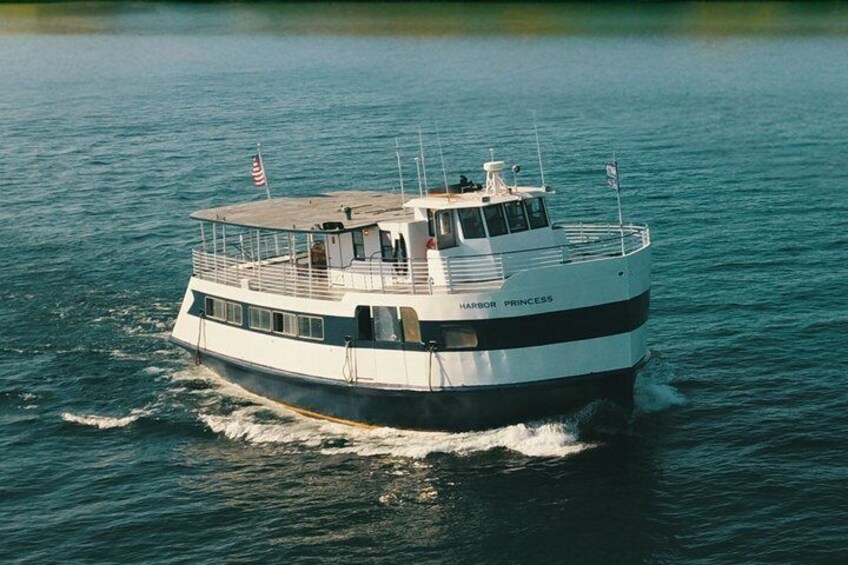 A white and black boat named 'Harbor Princess' on water. 1