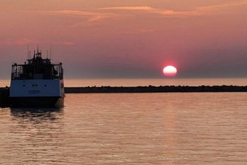 A boat on calm water during sunset. 3