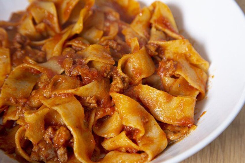 A plate of pasta with a tomato-based sauce. 3